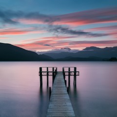 Romantic wharf on Te Anau on South Island of New Zealand Beautiful pier on sunrise. Lake Te Anau is the largest lake in the South Island and within New Zealand second only to Lake Taupo.
