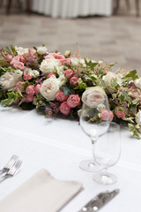 Beautiful floral arrangement on the table in the restaurant on the wedding day