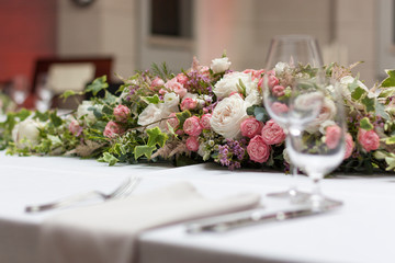 Beautiful floral arrangement on the table in the restaurant on the wedding day