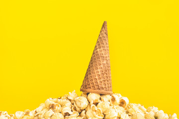 Pop corn with ice cream cone on pastel color background