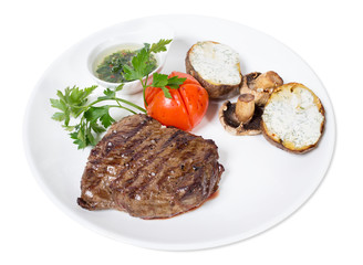 Beef steak with chimichurri sauce and vegetables.