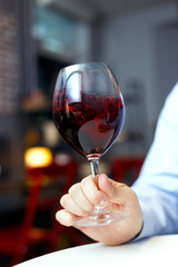 male sommelier is checking and testing red wine