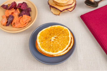 Naklejka na ściany i meble Healthy food organic nutrition. Sliced and dried apple, orange, carrot and beetroot on textile background.