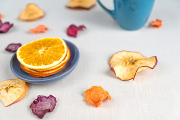 Healthy food organic nutrition. Sliced and dried apple, orange, carrot and beetroot  on textile background.