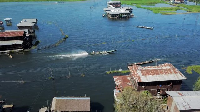 Aerial: Boats Pulling up to Building