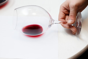 male sommelier is checking and testing red wine