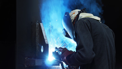 Fototapeta premium Welder is welding flux cored arc welding ,Industrial welding part in Oil and Gas or Petrochemical