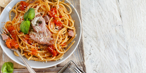 Pasta with chunks of fresh tuna, tomato and capers