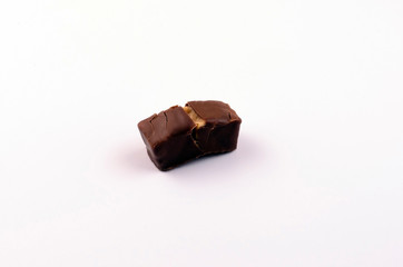 chocolate candies with nuts and caramel on a white background