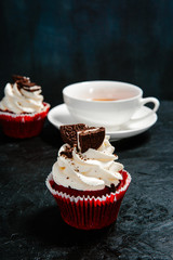 Cupcake with cream cap and a Cup of tea