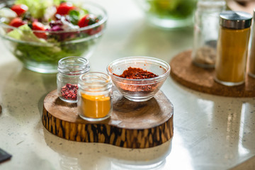 Close up of spices on the wooden stand on the table