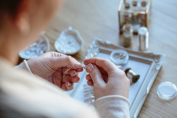 Closeup macro photo of details, workplace of decorator and creator of wedding imitation jewelry....