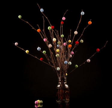 Easter Tree with colorful decorations on black background, copy space
