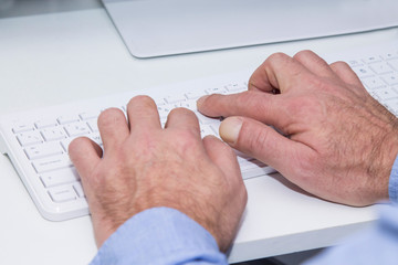 male hands are pressing the keyboard