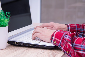 male hands are pressing the keyboard