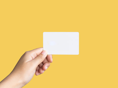 Holding up  white business card mockup   on pastel color background. 