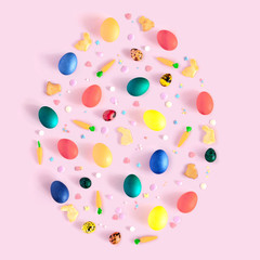 Top view and flat lay of arrangement decoration Happy Easter, holiday background concept. Colorful bunny cookies, eggs and topping ornament design as big egg on pink pastel desk.