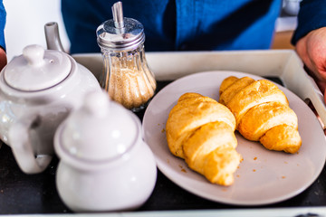 breakfast in bed with coffee, croissants, strawberries and juice