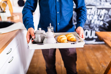 breakfast in bed with coffee, croissants, strawberries and juice
