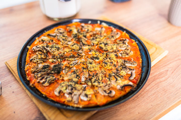 pizza sliced on a black tray