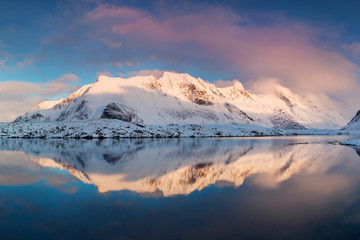 Obraz na płótnie Canvas Panoramic landscape, winter mountains and fjord reflection in water. Norway, the Lofoten Islands. Colorful winter sunset or sunrise above the arctic circle. Christmas time concept