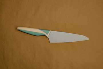 blue ceramic knife on brown background