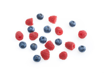Raspberries and blueberries white background top view