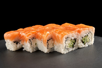 Philadelphia roll covered with fresh salmon.