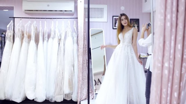 girl posing and taking pictures in a wedding store