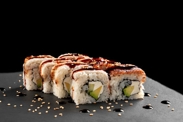 Sushi rolls with smoked eel, avocado, cream cheese.