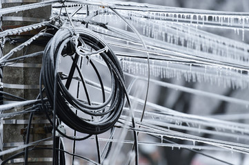 Electricity cables covered in ice after frozen rain phenomenon