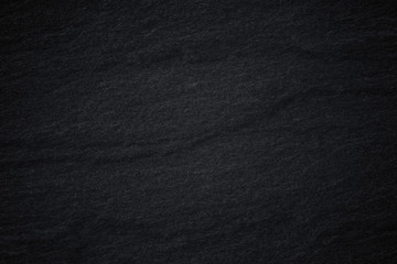 Dark grey black slate background or natural stone texture.