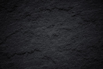 Dark grey black slate background or natural stone texture.