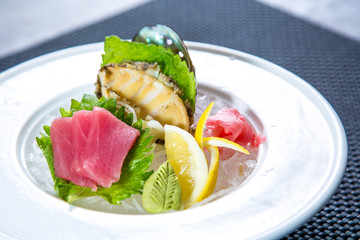 Asian cuisine, sushi, ice cubes, shrimp, salmon, close-up, mint leaves. Fish and meat