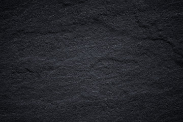 Dark grey black slate background or natural stone texture.