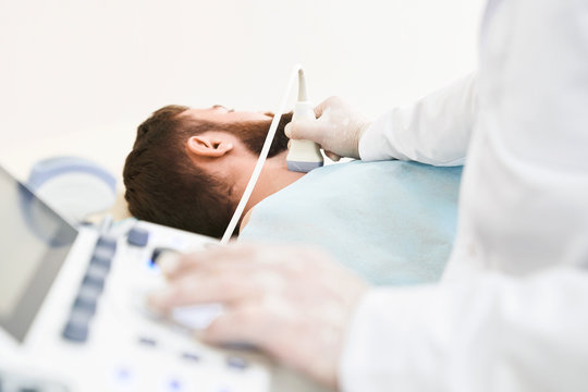 Medical Specialist Doing Ultrasound Diagnosis Of Neck.