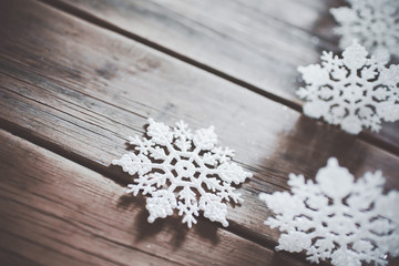 Obraz na płótnie Canvas Christmas decor. White snowflakes on wooden background. 