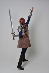 full length portrait of a  red haired girl wearing medieval warrior costume and steel armour,...