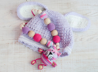 Fototapeta na wymiar Knitted pink striped handmade crafted cat. Children's toy. Crochet pattern.