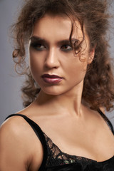 Seductive model in black bra looking away.