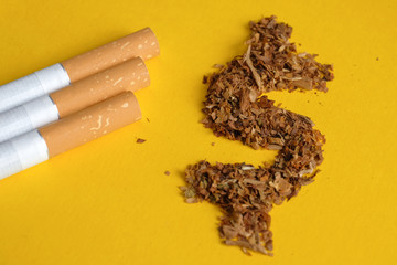 US dollar sign of tobacco with cigarettes on a yellow background. Top view.