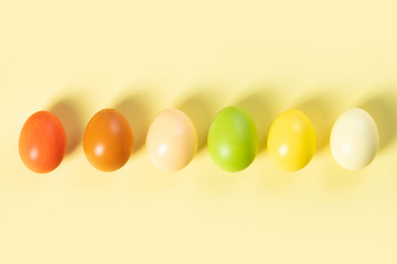 stylish easter flat lay, easter eggs on yellow background