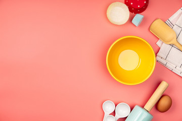 Baking or cooking ingredients on pink background, flat lay