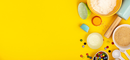 Baking ingredients on yellow background, flat lay