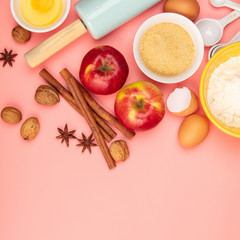 Baking or cooking ingredients on pink background, flat lay
