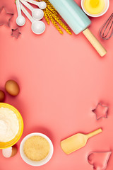 Baking or cooking ingredients on pink background, flat lay