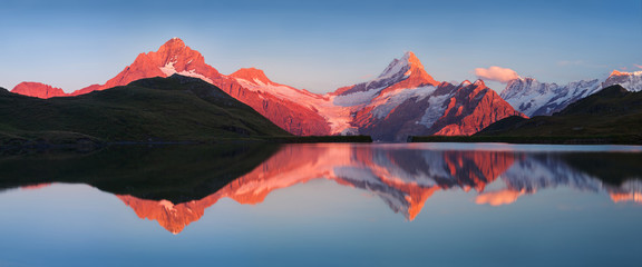 Beautiful evening panorama from Bachalp lake / Bachalpsee, Switzerland. Picturesque summer sunset...