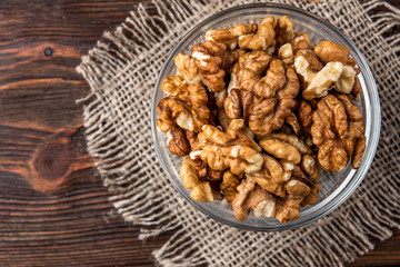 Walnut on dark wooden background.