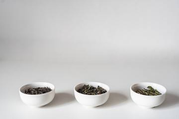 the white drinking bowls of chinese tea in order  on white background