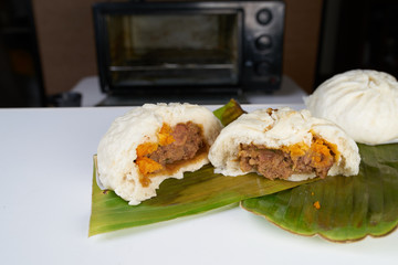 steamed stuff bun on white table